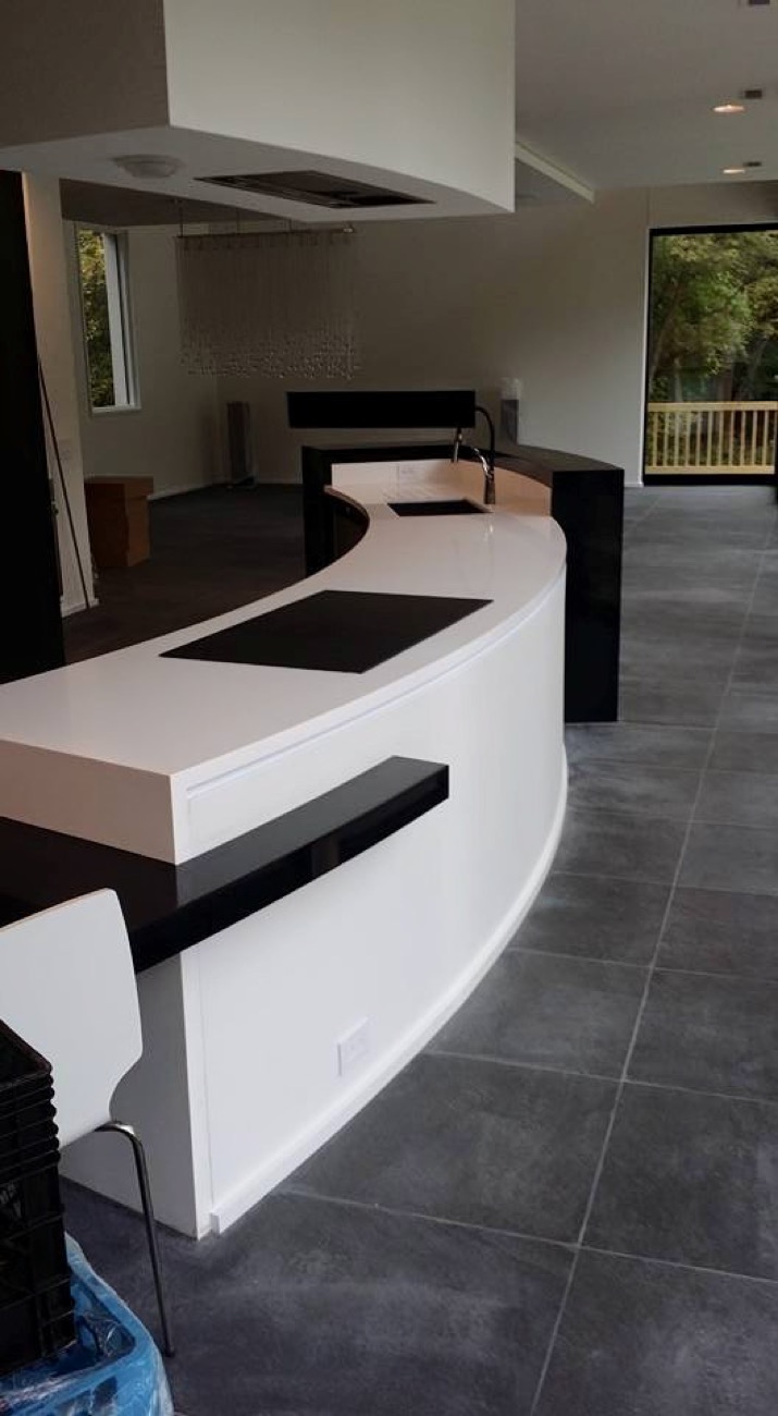 A curved white solid surface bar fabricated by Argent's Solid Surface Shop