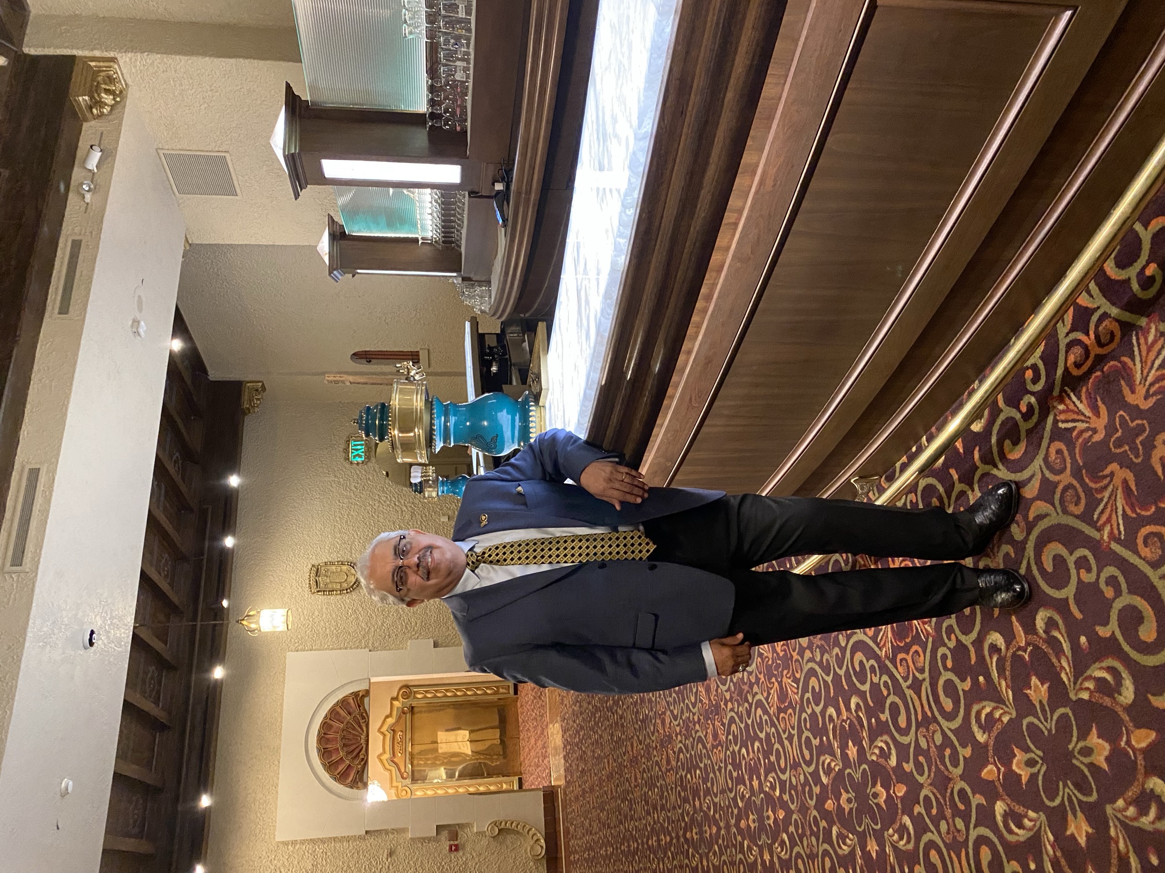 Founder José Alejos beside a custom backlit marble bar built by Argent Concepts